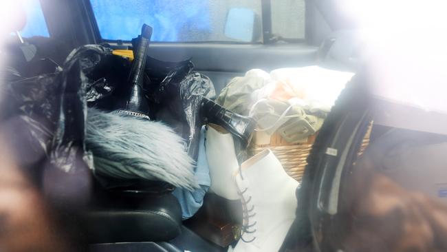 Large amount of clothes on the front seat of a green Toyota Ute which was found parked at the crime scene at Burleigh Stocklands Shopping Centre after a woman was found dead inside a charity clothing bin. Picture: NCA NEWS WIRE / Scott Powick