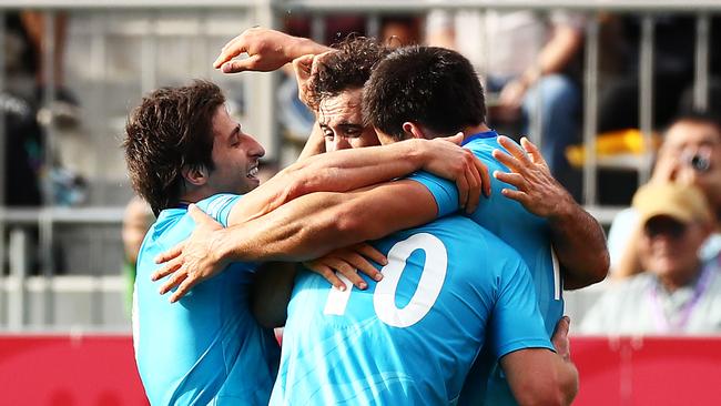 Juan Manuel Cat (C) is congratulated by his Uruguay teammates after a stunning first-half try in their shock upset of Fiji. Picture: Getty