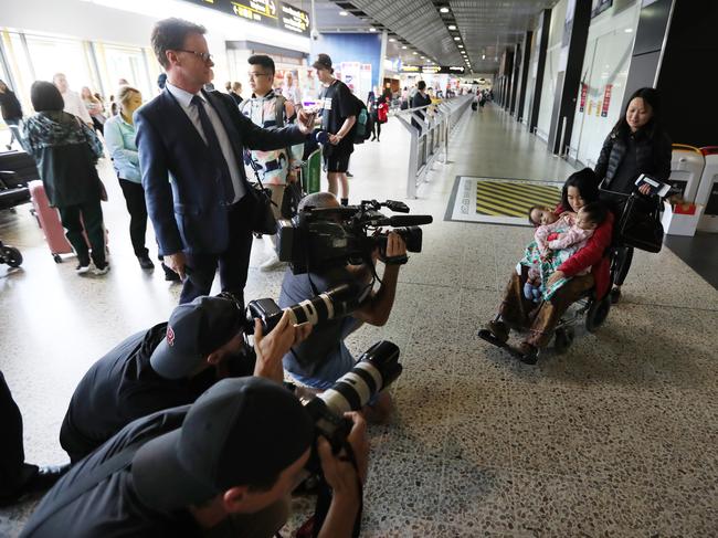 Bhumchu Zangmo clings to her now-famous twins Nima and Dawa as she passes through crowds of media and wellwishers at Melbourne airport. Picture: Alex Coppel