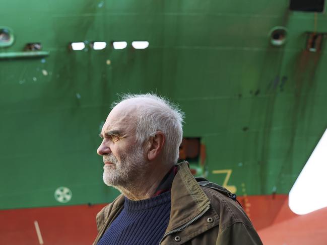 Johan Helberg stands next to his house with the container ship NCL Salten in the background. Picture: Jan Langhaug / NTB / AFP