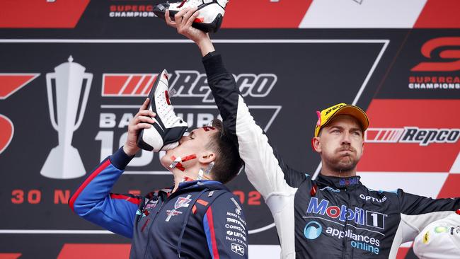 Walkinshaw Andretti United team owner Ryan Walkinshaw and Chaz Mostert celebrating with a Shoey on the podium after winning the Repco Bathurst 1000 at Mount Panorama today. Picture: Tim Hunter.