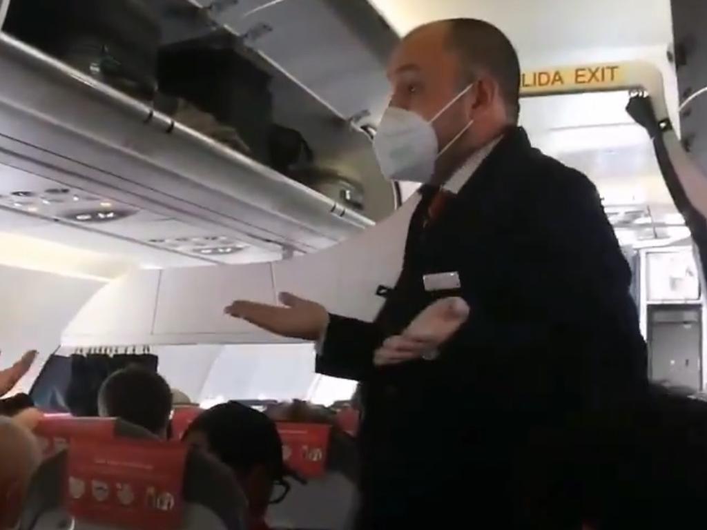 Incensed travellers were filmed arguing with a flight attendant.