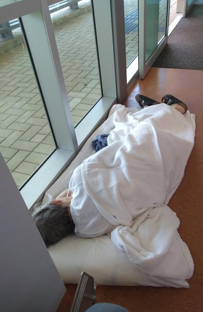 An image of an 84-year-old woman forced to lie on the floor of a hospital has sparked outrage.