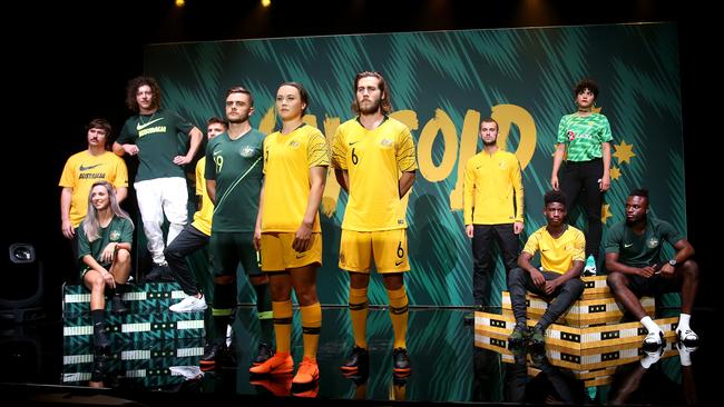 Josh Risdon, Caitlin Foord and Josh Brillante (left to right at front) model the new Socceroos/ Matilda kit at a launch event in Marrickville on Thursday night