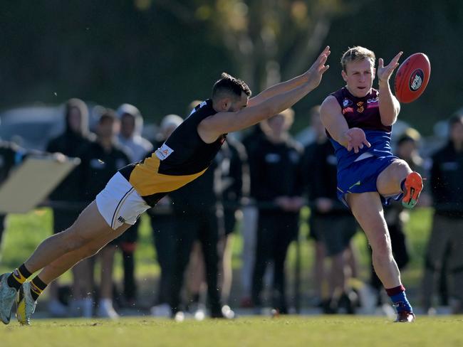 NFNL: Heidelberg’s Kieren Andrew tries to stop Jack Raines of Banyule. Picture: Andy Brownbill