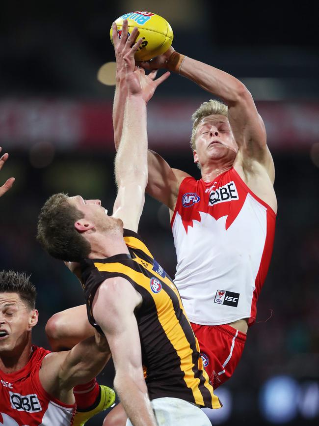 Isaac Heeney climbs above Ben McEvoy to mark against Hawthorn.