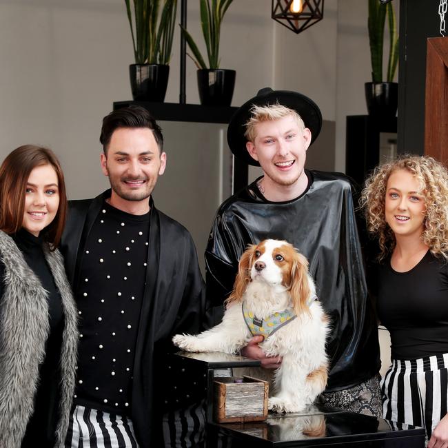 Owners Mark and Chris with stylists Caprice-Rose Chalmers (left) and Harriet (right) and salon pooch Elli-May. Picture: Sue Graham