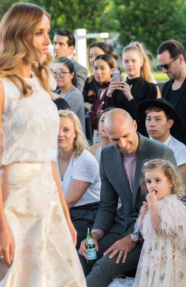 Rebecca Judd models while her husband daughter, Billie, watch on.