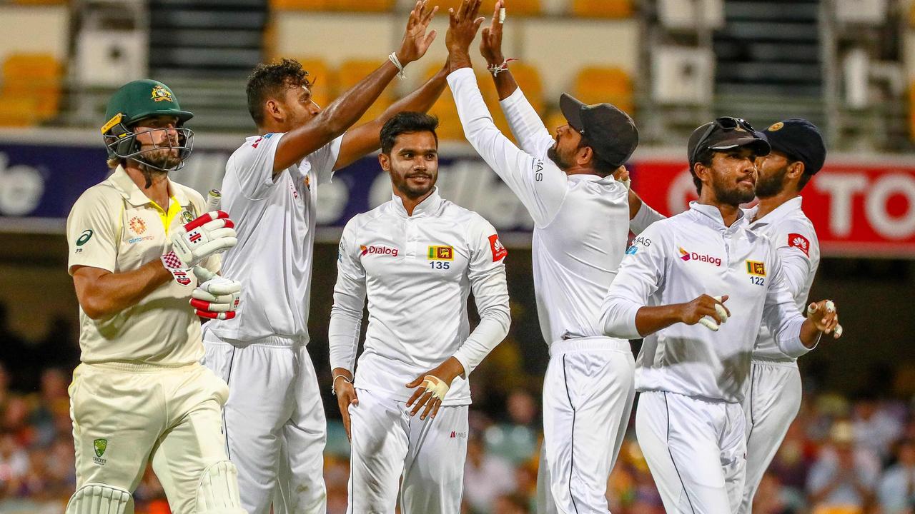 Sri Lanka celebrate the wicket of Joe Burns. Photo: Patrick Hamilton/AFP. 