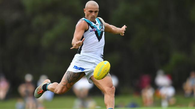 Powell-Pepper sends the ball forward against Brisbane. Picture: AAP Image/Darren England