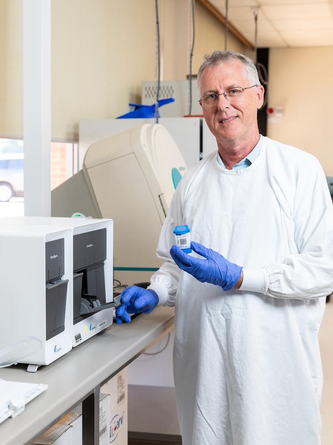 Alice Springs Hospital Pathology Department microbiology supervising scientist James McLeod with the unit used to process coronavirus tests. Picture: EMMA MURRAY