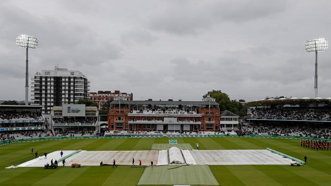 The covers are on after rain stops play on the third day of the second Ashes Test match between England and Australia at Lord's. Picture: AFP