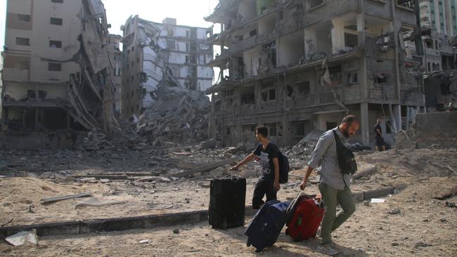 Palestinian citizens evacuate their homes damaged by Israeli air strikes on October 10, 2023 in Gaza City, Gaza. (Photo by Ahmad Hasaballah/Getty Images)