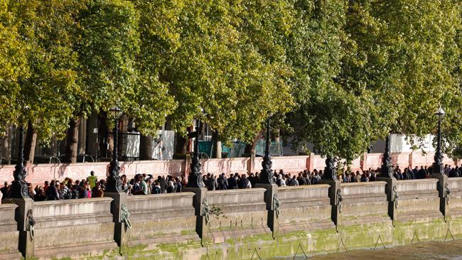 Members of the public queue on London’s South Bank to pay their respects to the late Queen Elizabeth II, lying in state at the Palace of Westminster.