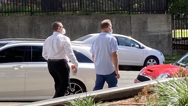 Mark Horsfall (left) leaving Wollongong Local Court.