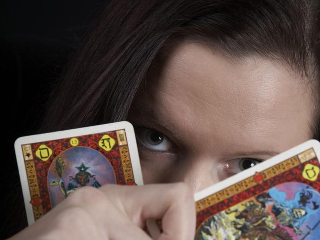 Generic image of a psychic woman telling fortune with tarot cards.