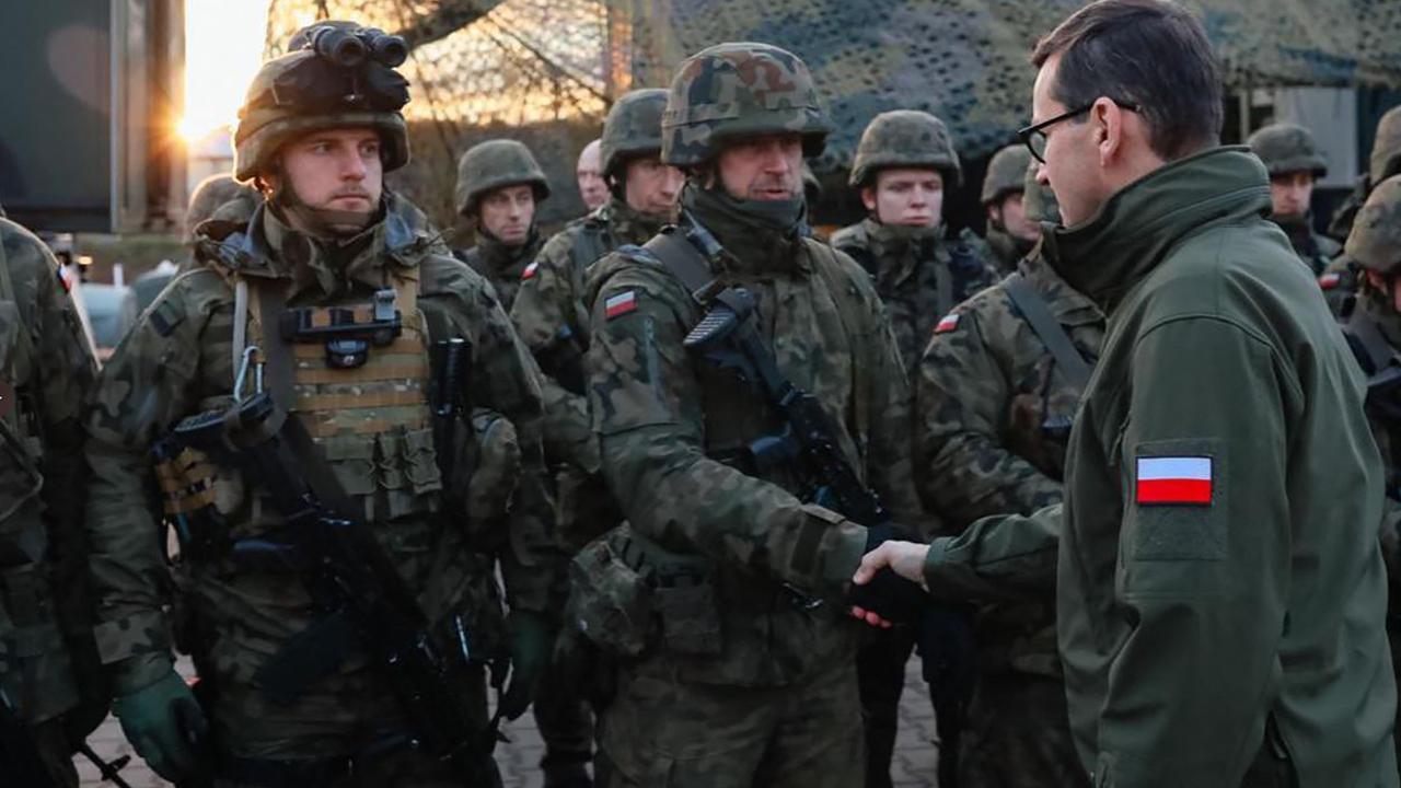 Poland's Prime Minister Mateusz Morawiecki (R) visits border guards and troops at the border with Belarus near Kuznica. Picture: Handout/Polish Defence Ministry/AFP