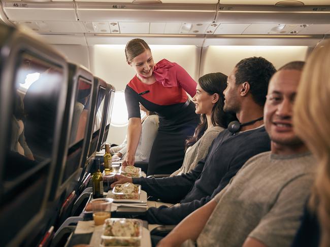 From Jan 20, Qantas will be offering direct seasonal flights from Sydney to Sapporo’s New Chitose Airport, to help make it easier for travellers to reach Hokkaido’s world-class ski resorts on Japan's northernmost island. Picture: Supplied/Qantas.    Inflight economy cabin passengers are getting food served in Qantas A330