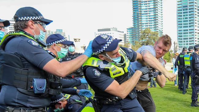 A policeman is punched by a protestor at the Shrine. Picture: Alex Coppel