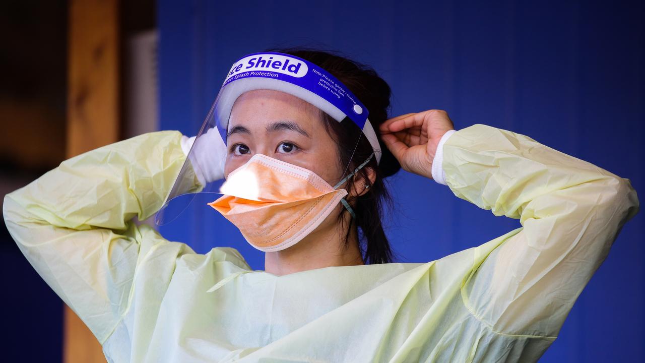 A nurse is seen adjusting her protective face mask. Picture: NCA NewsWire / Gaye Gerard