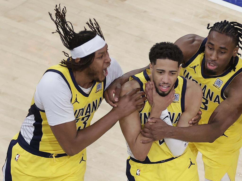 Indiana Pacers guard Tyrese Haliburton (0) is mobbed by teammates as he makes a choking motion after hitting a shot against the New York Knicks. Picture: AP/Adam Hunger