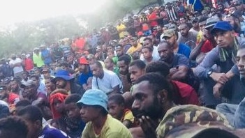 PNG villagers watching Olam and the Melbourne Storm in the NRL.