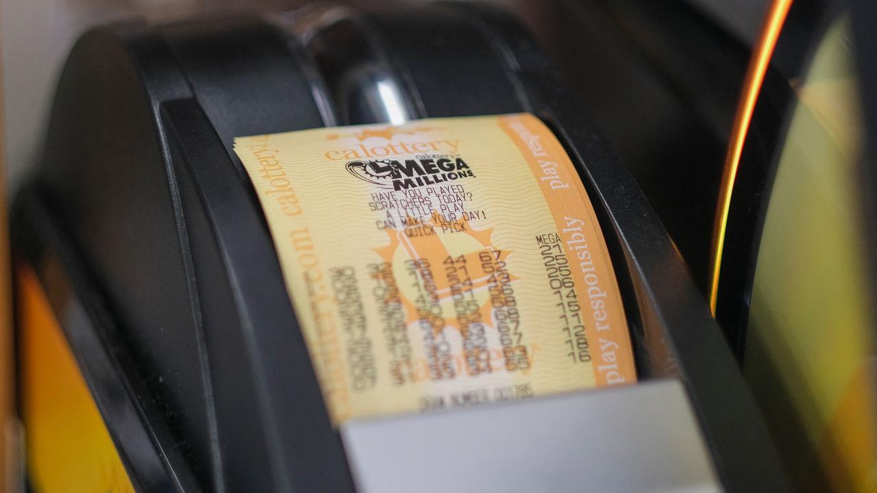 A machine prints a Mega Millions lottery ticket at a 7-Eleven. Picture: Ringo Chiu/AFP