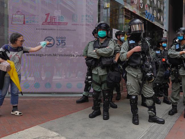 A woman gives riot police a piece of her mind. Picture: AP