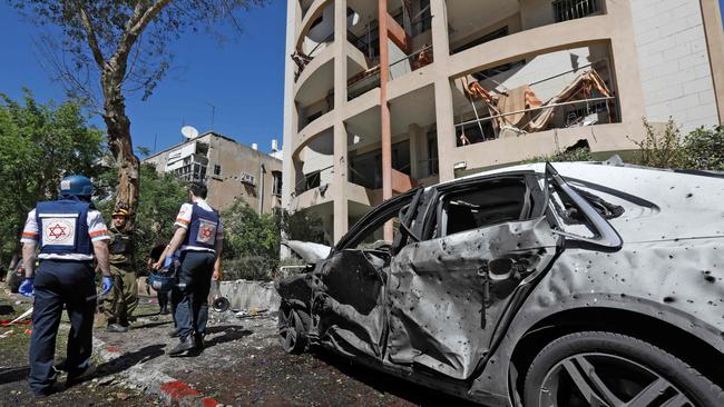 Members of Israeli security and emergency services work on a site hit by a rocket in Ramat Gan near Tel Aviv.