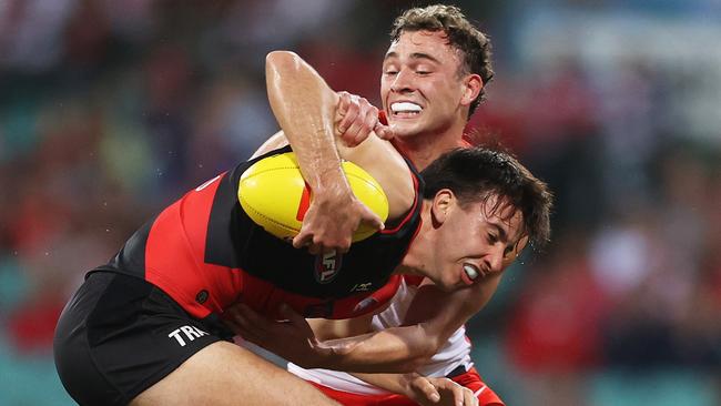 Nic Martin of the Bombers is tackled by Will Hayward. Picture: Matt King/AFL Photos/via Getty Images