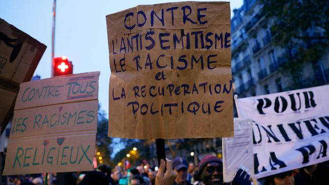 Protesters holding placards which read Against All Religious Racisms, Against anti-Semitism, Against Racism and Political Recuperation in a march against anti-Semitism in Paris on November 12. Picture: AFP