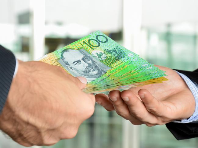 Hands of businessmen passing money, Australia dollar bills