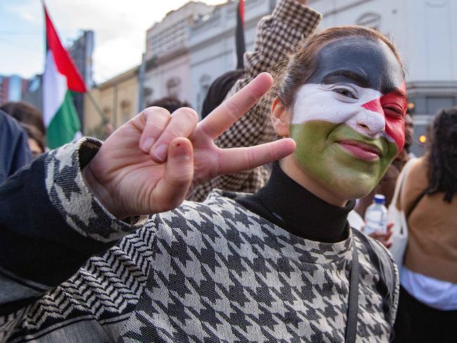 A protester flashes a peace sign at a Free Palestine rally on Saturday. Picture: NCA NewsWire/Sarah Matray