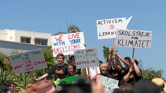 STRIKE FORCE: Students wave their banners high. Picture: Elliot Kirkwood