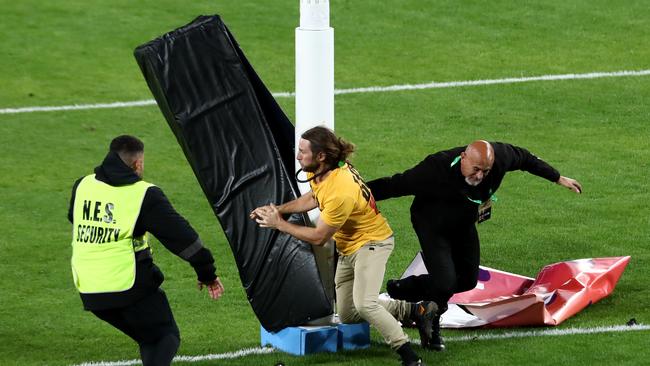 A pitch invaded removes padding from the goalposts.