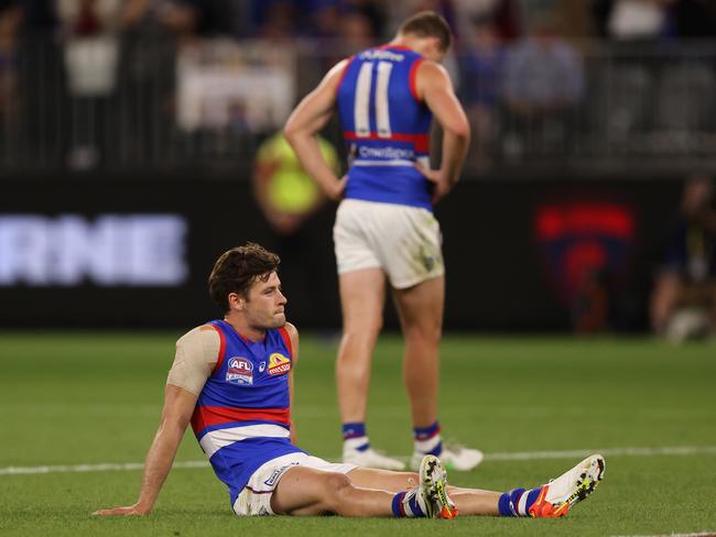 A dejected Josh Dunkley sits on the ground after the loss. Picture: Paul Kane/Getty Images