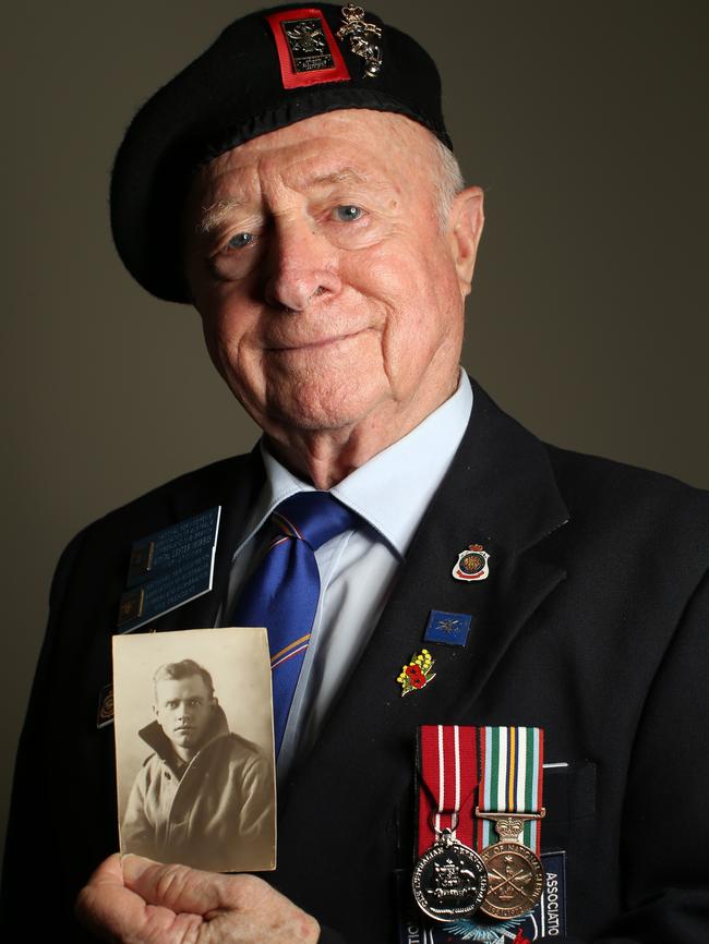 Lester Morris with a photo of his father Bernard. Lester and his brother Andy had hoped to honour their father at the Gallipoli Dawn Service but have been forced to return their tickets. Picture: Jonathan Ng