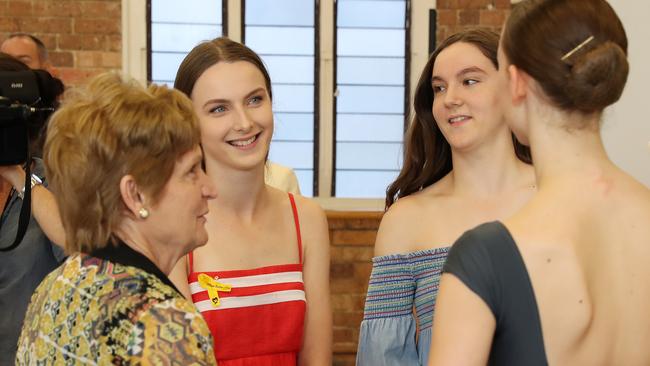 Allison Baden-Clay's two eldest daughters Hannah and Sarah, along with grandmother Priscilla Dickie, congratulate Taji Hennessy. Picture: Liam Kidston