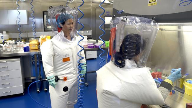 Virologist Shi Zheng-li, left, in the P4 lab of Wuhan Institute of Virology. Picture: Getty Images