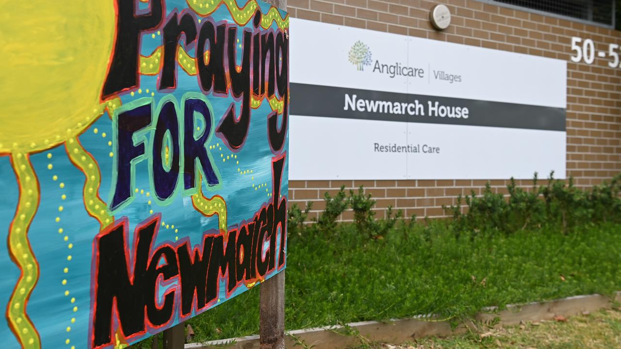 Signs and flowers left at the entrance to Newmarch House. Picture: Dean Lewins/AAP