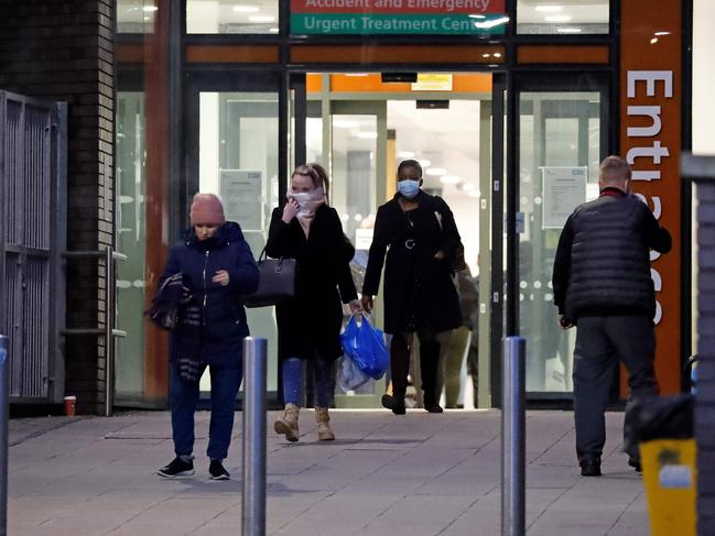 People wearing masks leave Northwick Park Hospital in London. Picture: AFP