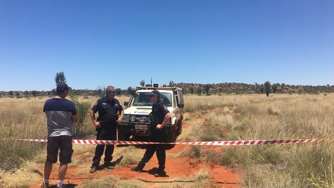 Supplied Editorial Police guard the scene where a scenic helicopter flight to Uluru crashed outside of Yulara.