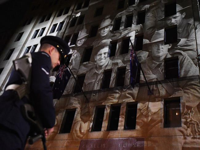An image showing soldiers is projected on a building during the Anzac Day Dawn service at Martin Place in Sydney. Picture: AAP