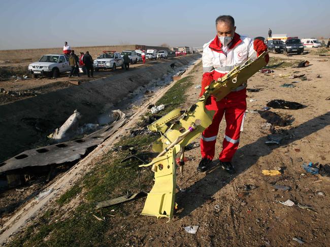 Rescue services recover debris from a field after a Ukrainian plane carrying 176 passengers crashed near Imam Khomeini airport near Tehran on Wednesday. Picture: AFP