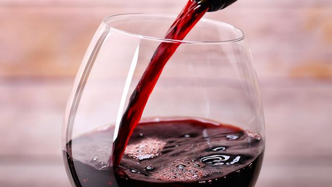 Pouring red wine int a glass