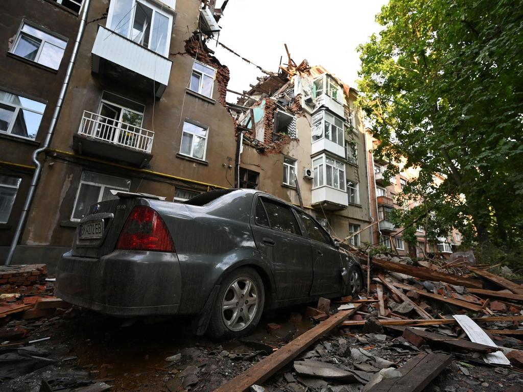 This photograph shows a car and a five-storey residential building partially destroyed after drones attacks killed two and wounded 19 in eastern Ukrainian city of Sumy on July 3, 2023, the regional administration said. Picture: SERGEY BOBOK / AFP