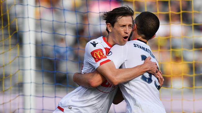 Craig Goodwin celebrates with Apostolos Stamatelopoulos after teaming up to score Adelaide United’s second goal in the drubbing of Central Coast. Picture: AAP Image/Brendan Esposito