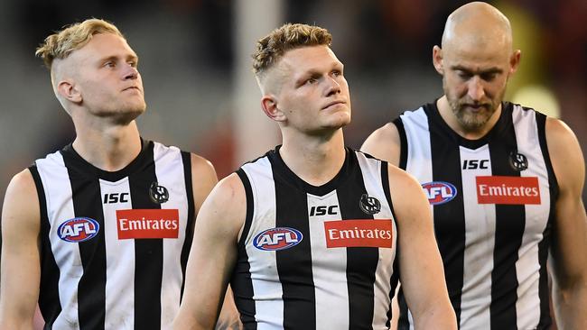 MELBOURNE, AUSTRALIA - SEPTEMBER 21: Jaidyn Stephenson, Adam Treloar and Ben Reid of the Magpies look dejected after losing the AFL Preliminary Final match between the Collingwood Magpies and the Greater Western Sydney Giants at the Melbourne Cricket Ground on September 21, 2019 in Melbourne, Australia. (Photo by Quinn Rooney/Getty Images)