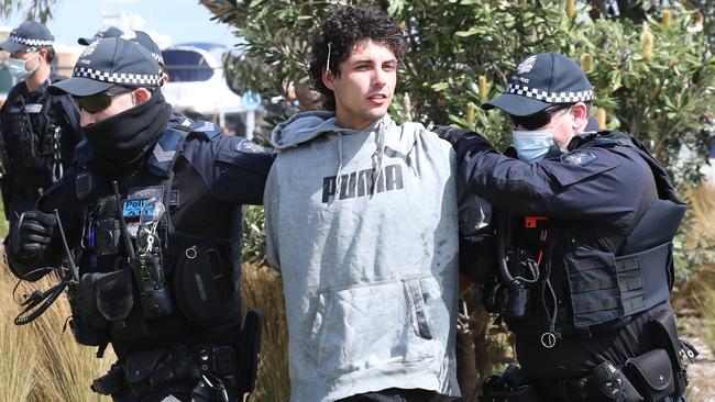 This man was led away by police during the protest. Picture: David Crosling