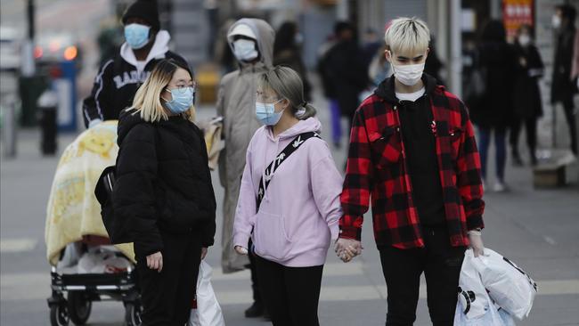 New Yorkers wear face masks as the city’s death rate surges. Picture: AP